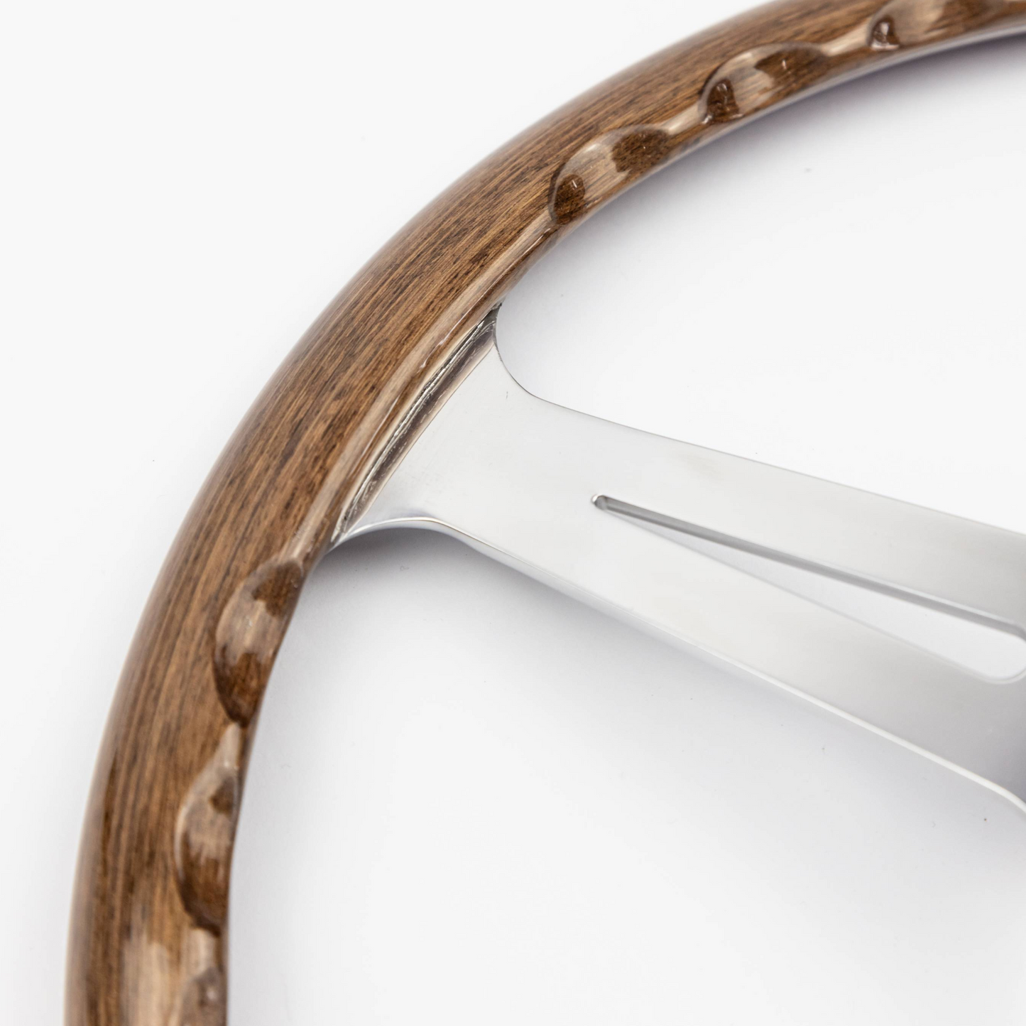 Close-up view of finger groove detail on 15-inch Les Leston Monte Carlo walnut steering wheel rim showing ergonomic cut-outs and wood grain finish