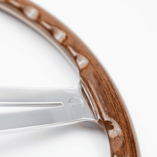 Close-up of the deep angled finger slots on the rear of a Les Leston wooden steering wheel