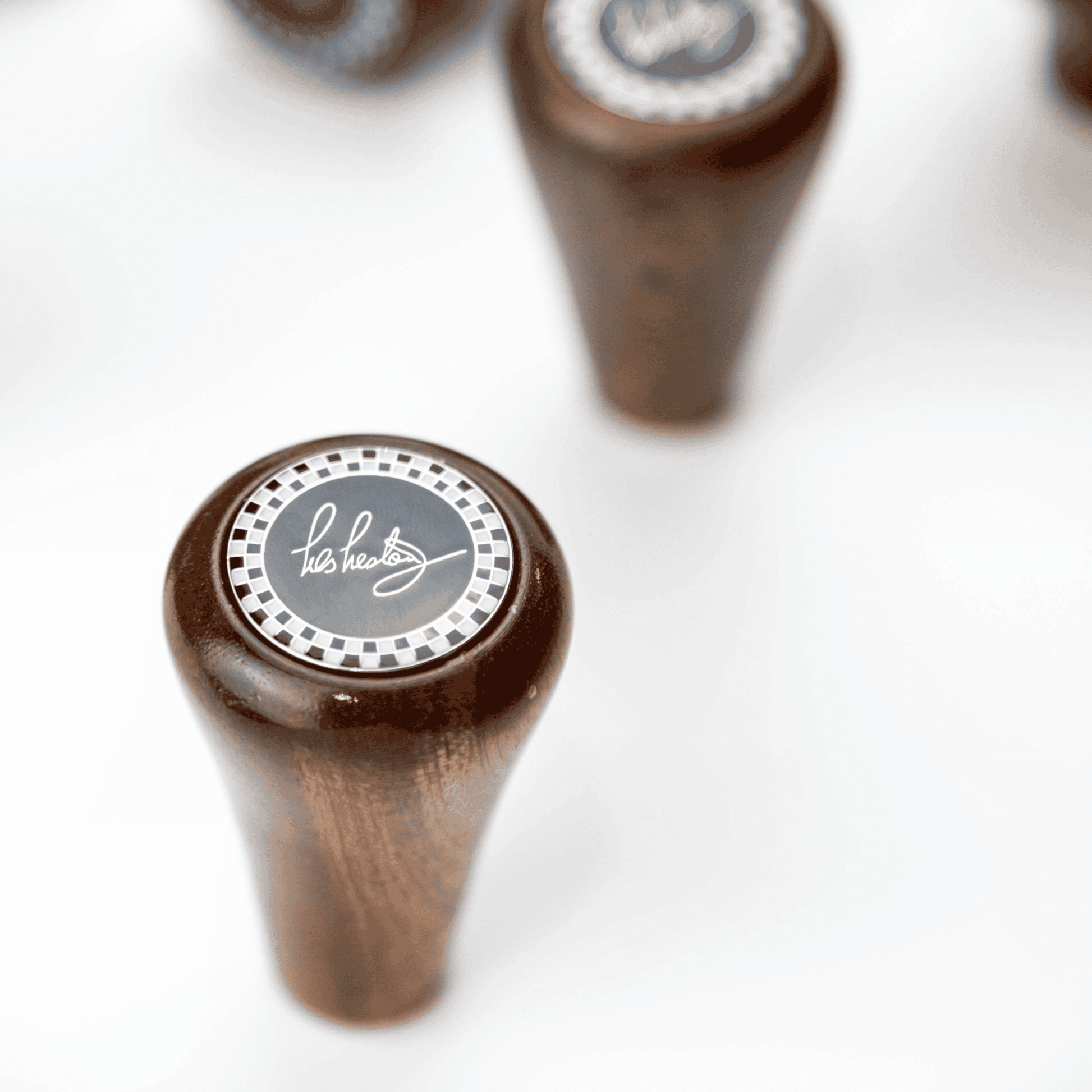 Close up of Les Leston Chevron mahogany wooden gear knob showing the triangular profile, rich wood grain and handcrafted finish for classic sports cars, GT cars and historic racing vehicles