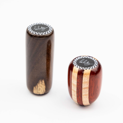 Close up of Les Leston Dadio wooden gear knob showing the contrasting maple and red hardwood striped grain and handcrafted finish inspired by the famous Dadio Lotus Elite