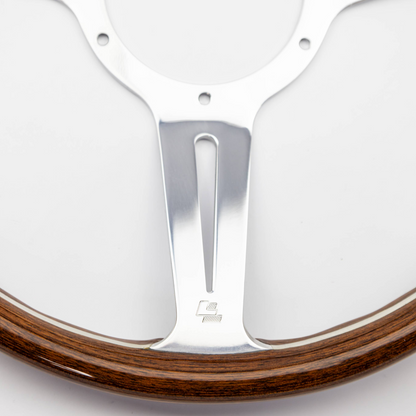 Close-up of “LL” Les Leston stamp on steering wheel rim indicating original manufacturer marking and authentic period-correct branding on Monte Carlo wheel construction