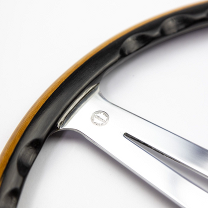 Detailed view of the handcrafted black oak and teak rim on a Les Leston Monte Carlo continuation steering wheel