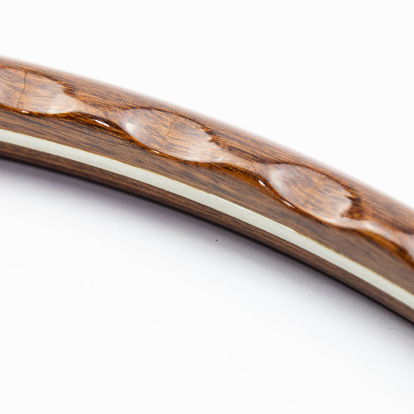 Close-up of finger grip slots on mahogany Les Leston Monte Carlo steering wheel rim showing ergonomic design