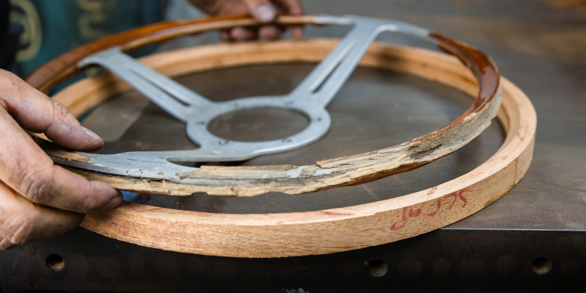Professional restoration of a Les Leston steering wheel, including wood refinishing, metal polishing and careful restoration to preserve its original character and period-correct appearance.
