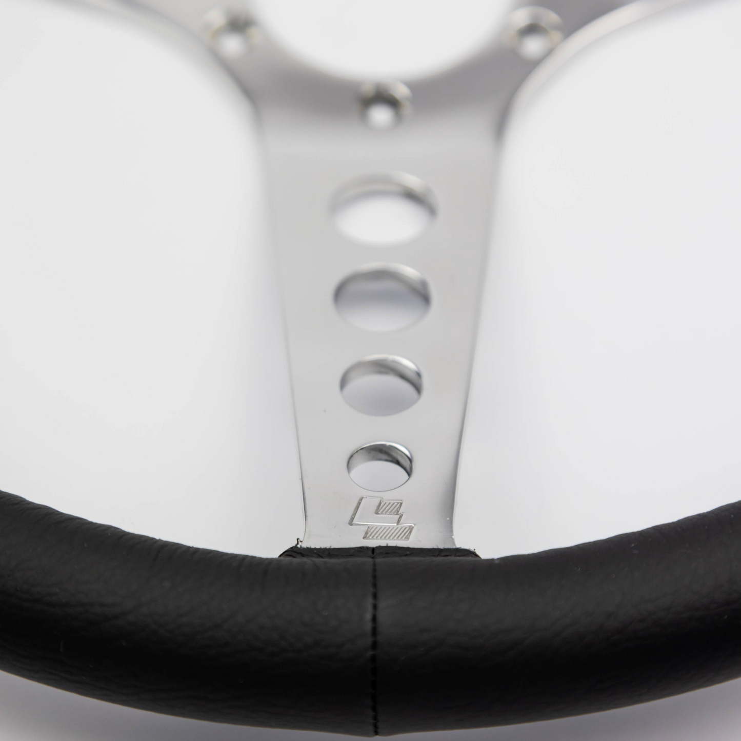Close-up of the hand-finished black leather rim on a Les Leston 14-inch dished steering wheel