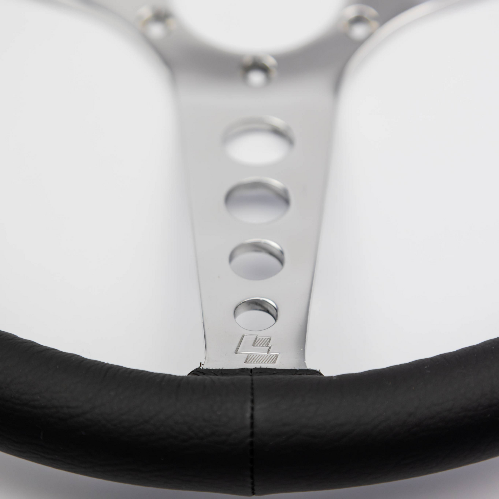 Close-up of the hand-finished black leather rim on a Les Leston 14-inch dished steering wheel