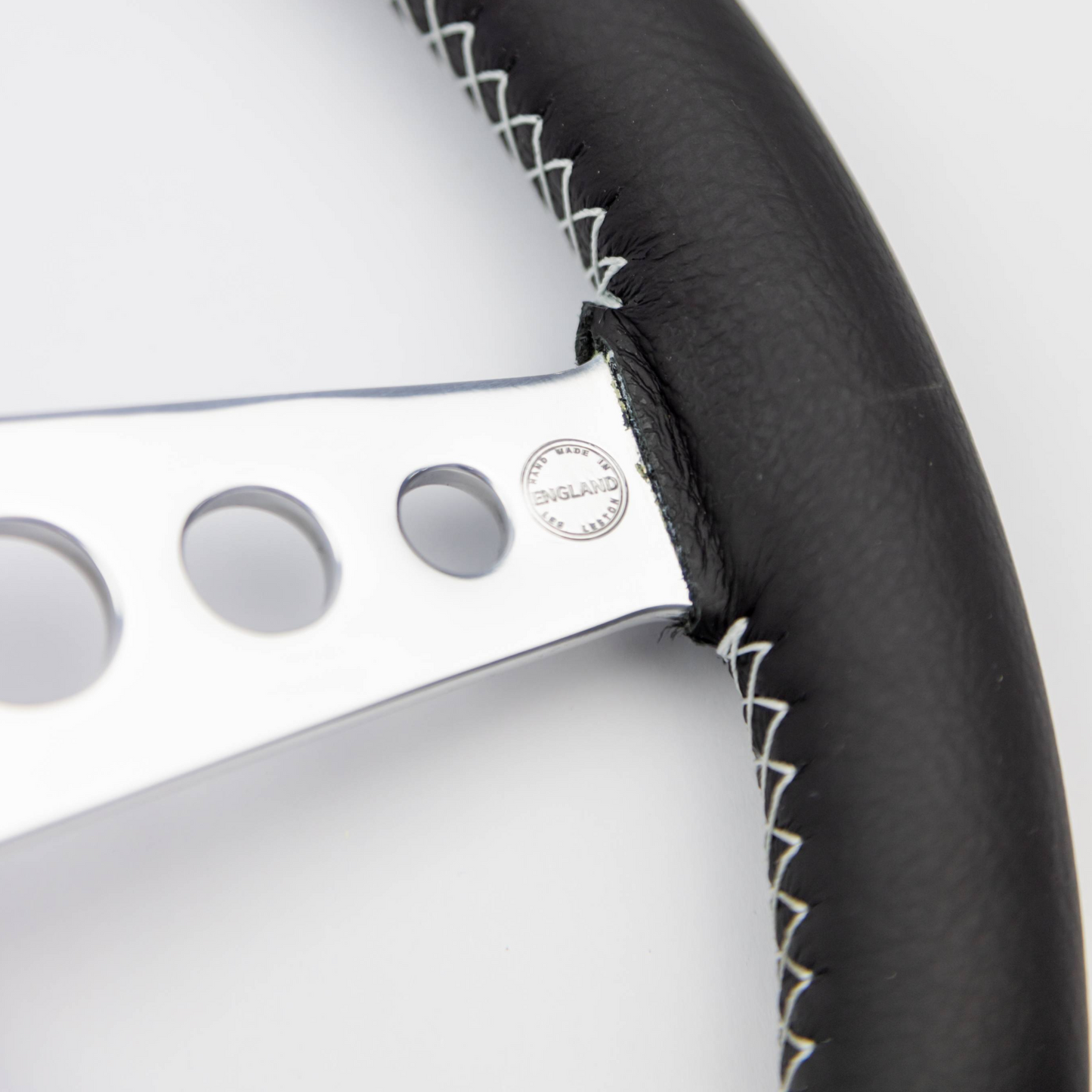 Close-up of the polished aluminium spokes on a Les Leston 14-inch dished leather steering wheel