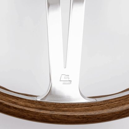 Close-up of Les Leston LL logo on 15-inch Monte Carlo steering wheel showing authentic maker's mark
