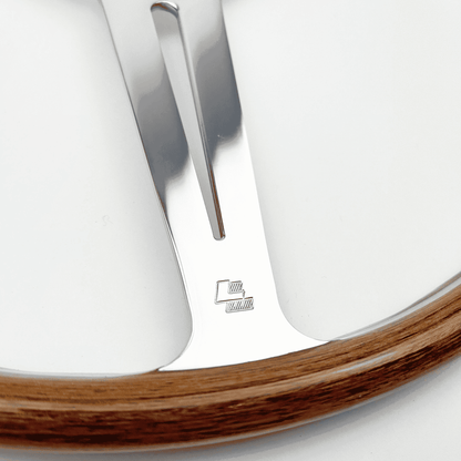 Close-up of the Les Leston LL stamp on the walnut rim of a 17-inch flat Monte Carlo steering wheel