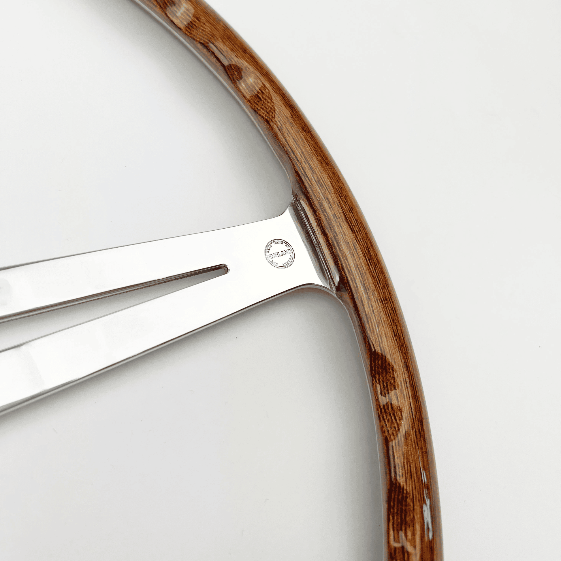 Close-up of the Made in England stamp on the walnut rim of a Les Leston Monte Carlo 17-inch flat steering wheel