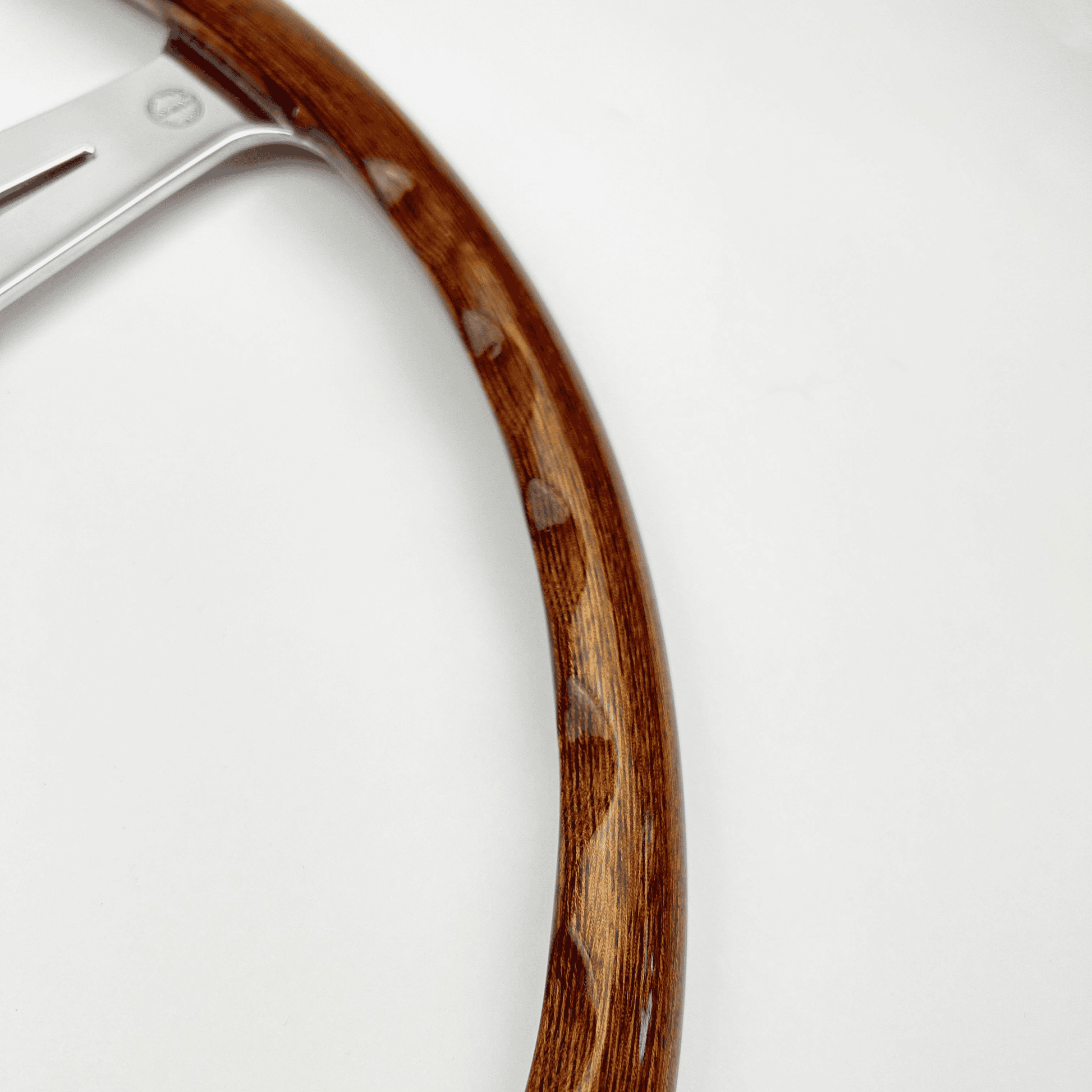 Rear view of Les Leston Monte Carlo 17-inch flat walnut steering wheel showing finger slot detailing and spoke construction
