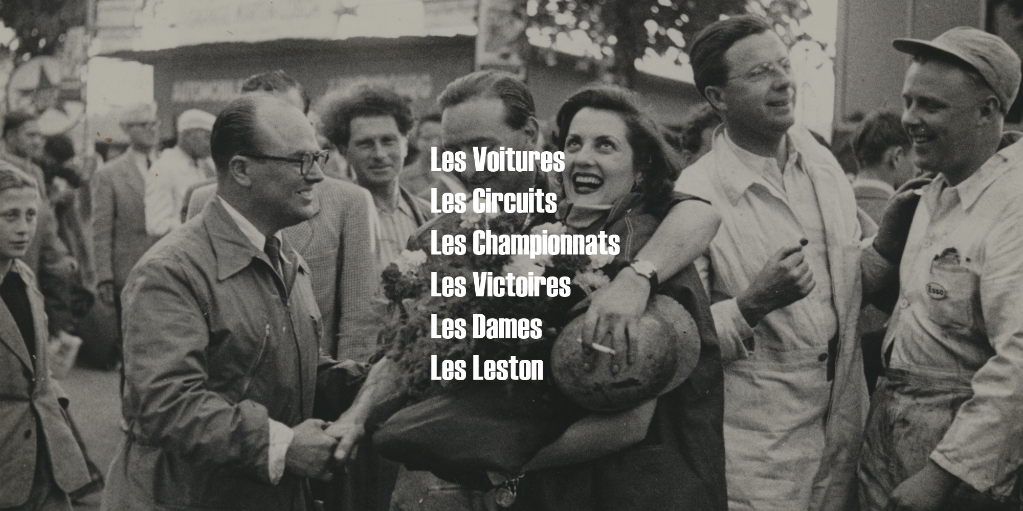 Les Leston celebrating a race victory with his wife in historic motorsport photograph with promotional Les Leston advertising slogan displayed