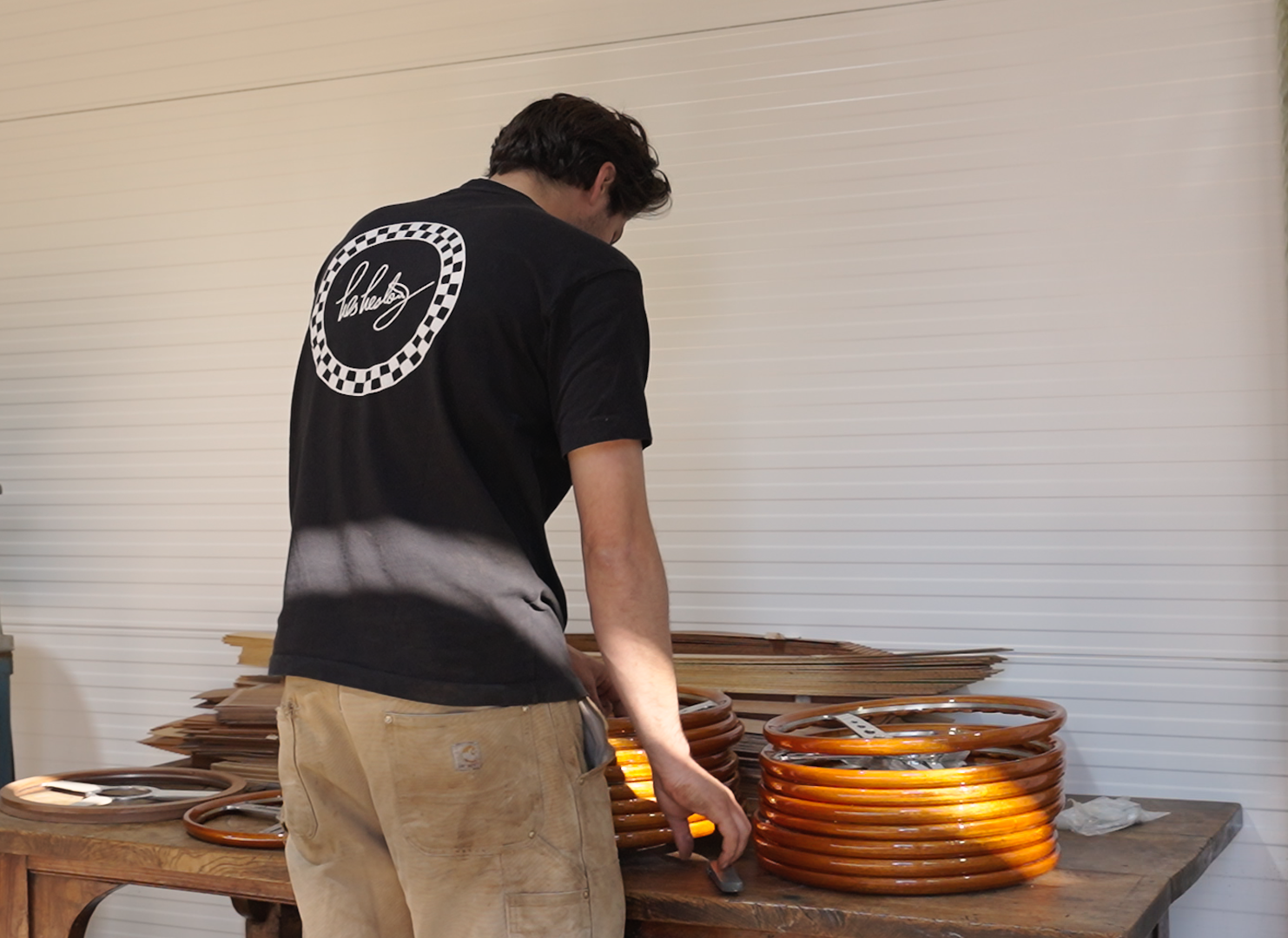Les Leston steering wheels displayed on factory workbench table showing current production and handcrafted manufacturing process