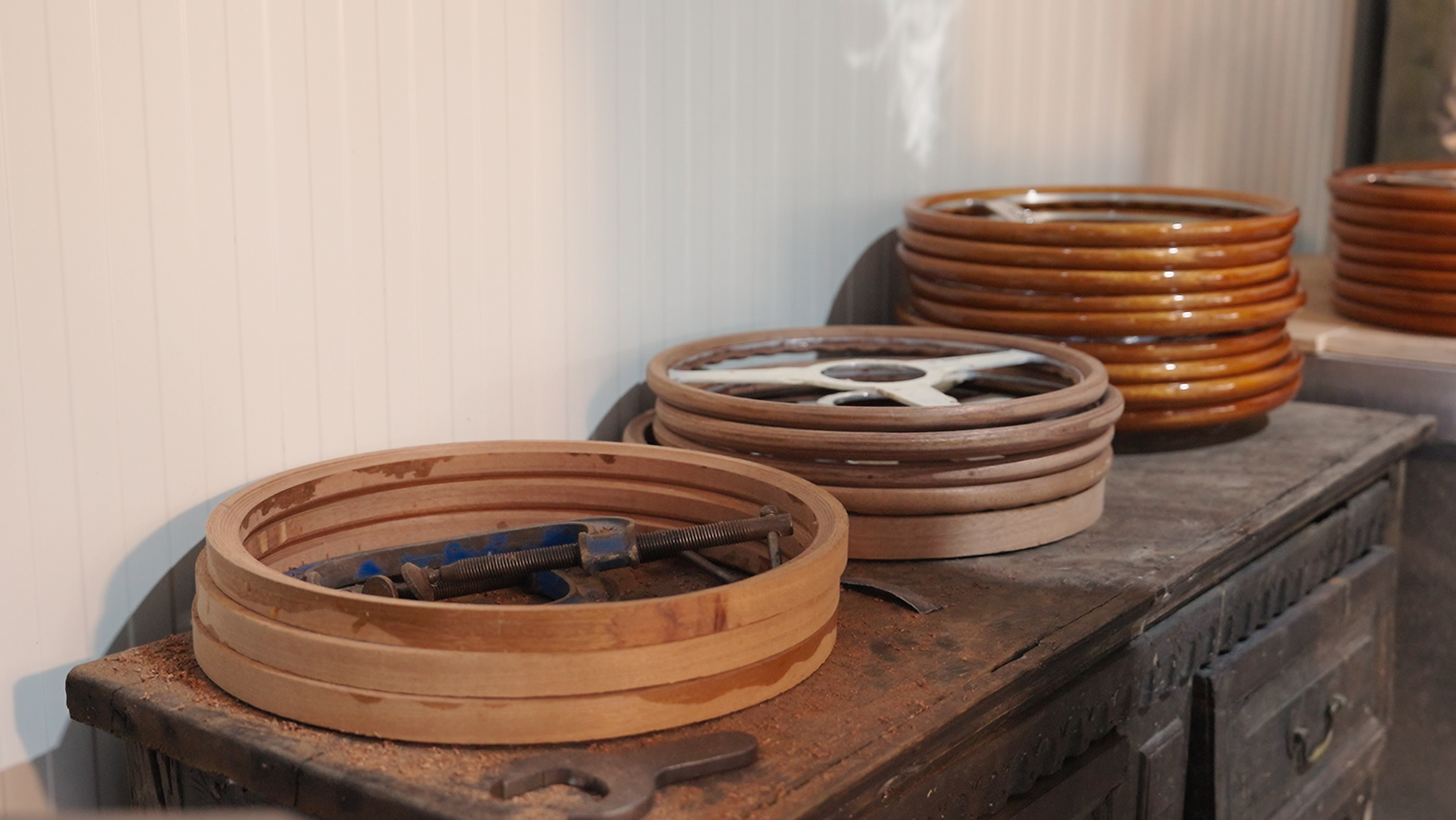 Les Leston steering wheels placed on dresser in factory workshop showing current production and handcrafted manufacturing process
