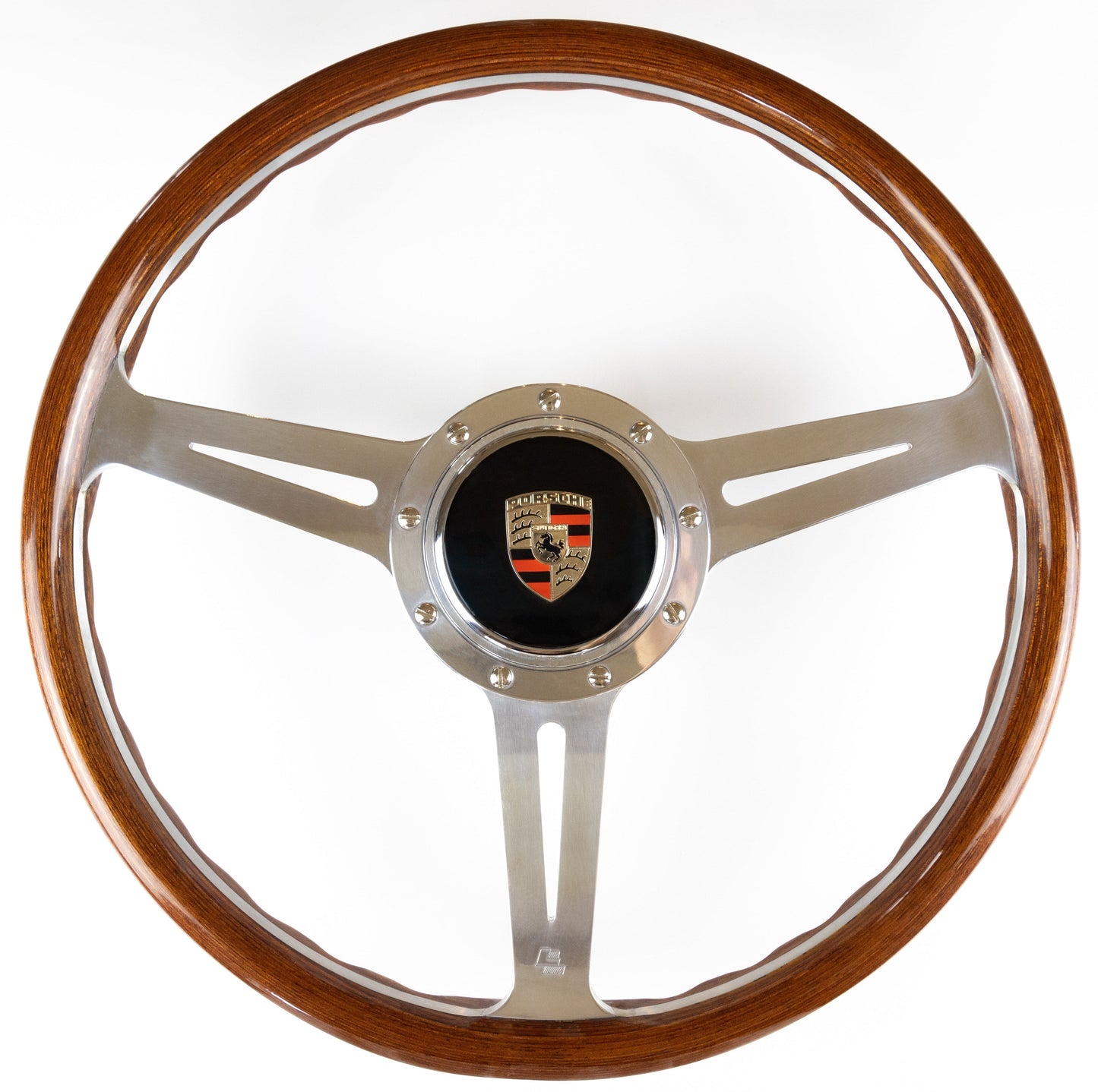 OEM Porsche horn button fitted to steering wheel centre showing installed position and authentic Porsche branding detail