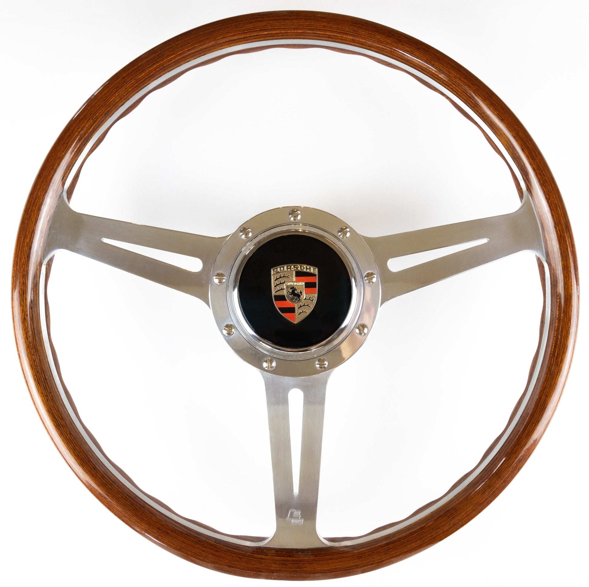 OEM Porsche horn button fitted to steering wheel centre showing installed position and authentic Porsche branding detail