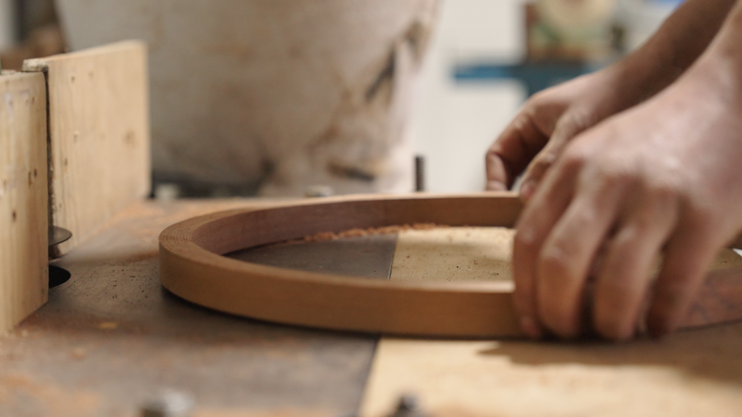 Ollie Leston manufacturing a Les Leston steering wheel on a spindle moulder in workshop showing handcrafted production process